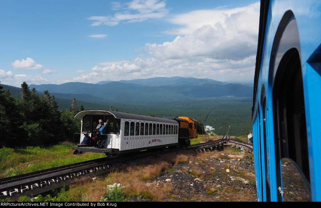 MWCR M7 (orange locomotive) on the way up passes by our train on the way down at Waumbek Water Tank